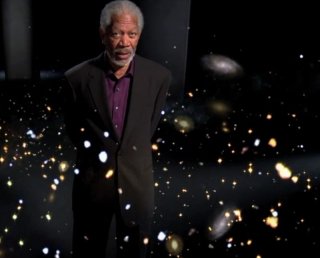 Morgan Freeman questions whether the universe could be infinite as he strolls through glowing stars in the episode “Is there an Edge to the Universe?” Image Courtesy of Discovery News.